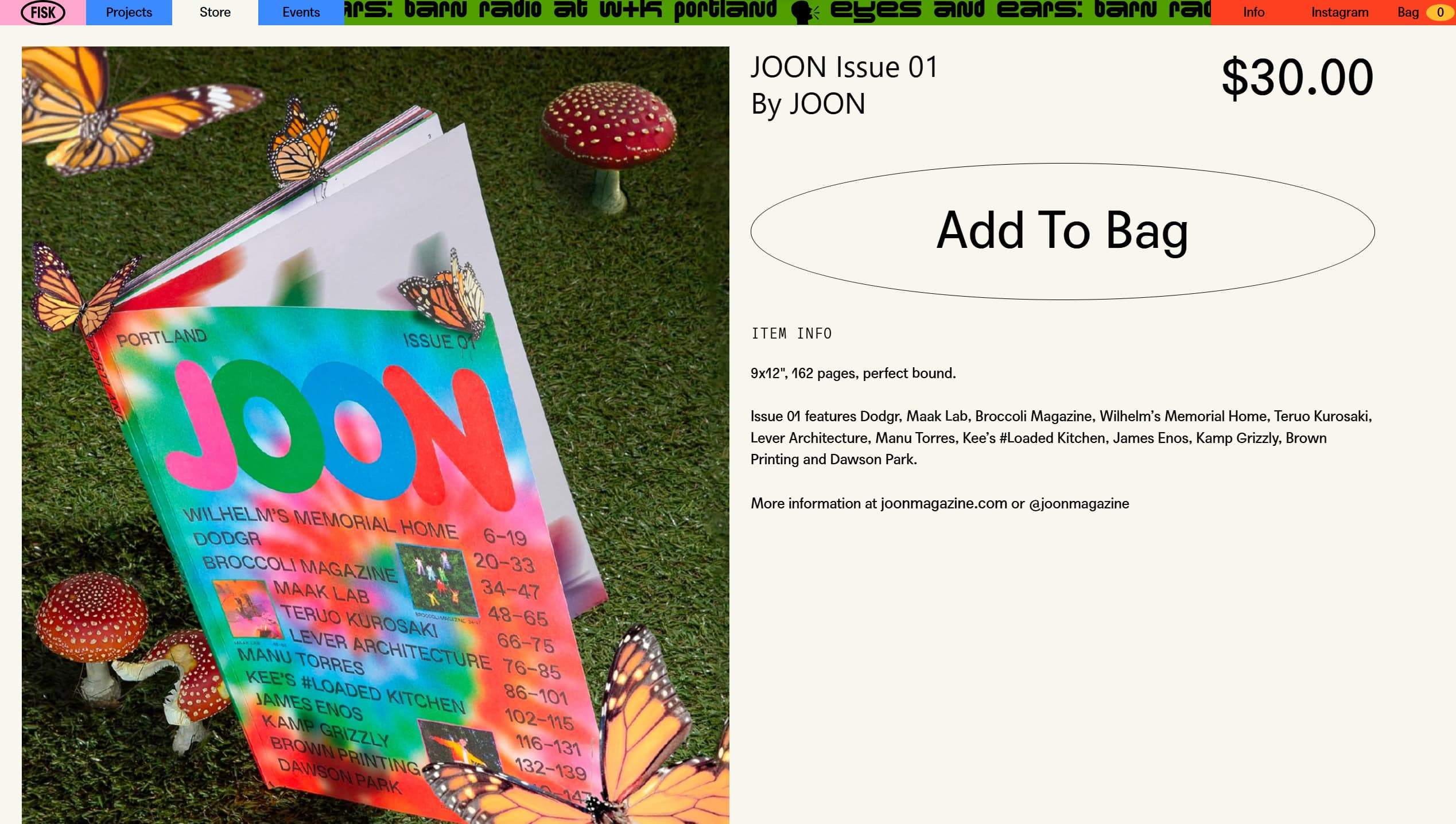A bright magazine cover with a rainbow gradient and butterflies resting on the edges, laid on grass beside red mushrooms.
