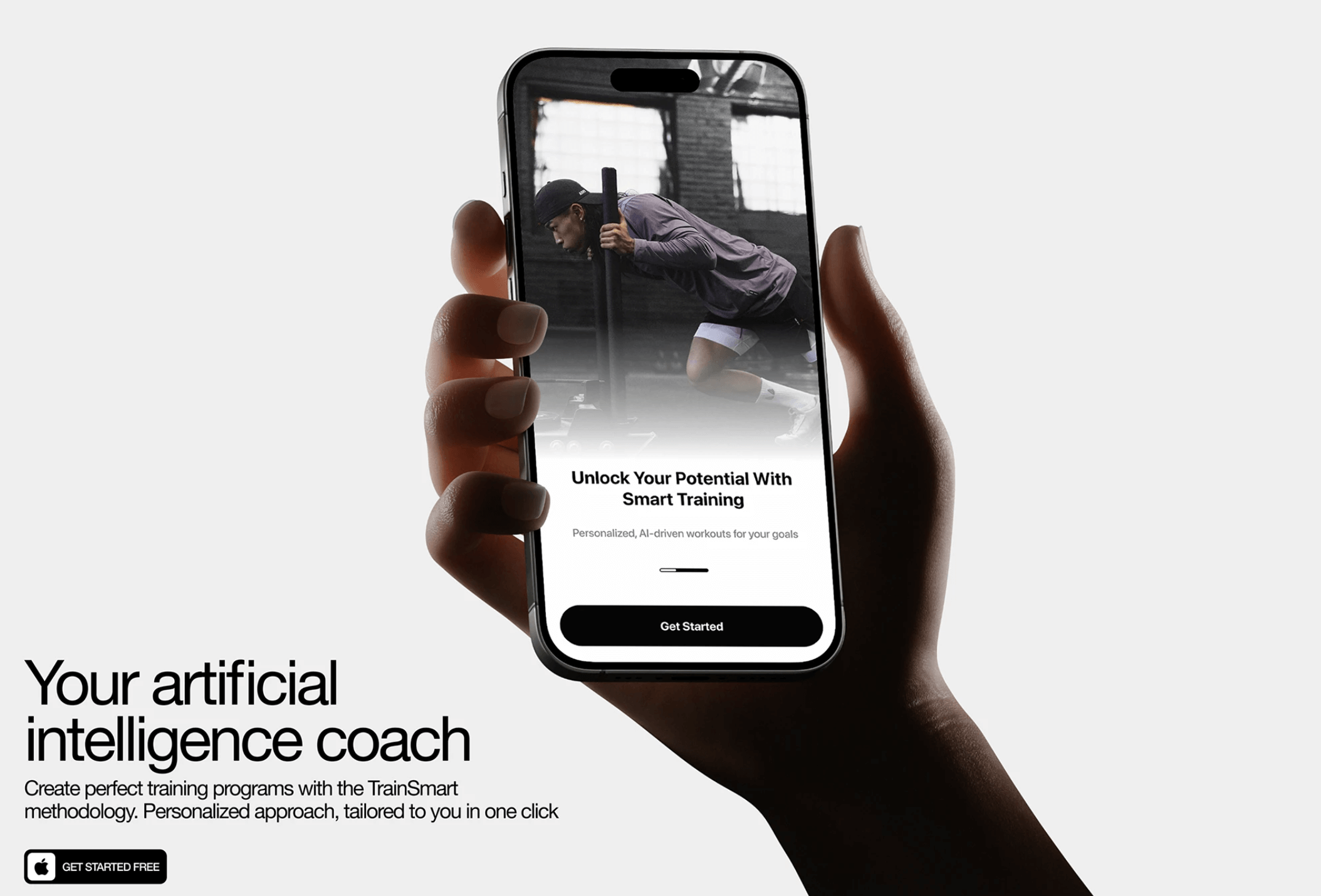 A hand holds a smartphone displaying a fitness app screen with a photo of an athlete pushing a sled and a prominent Get Started button at the bottom.
